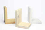 Three wooden bookends on a white background